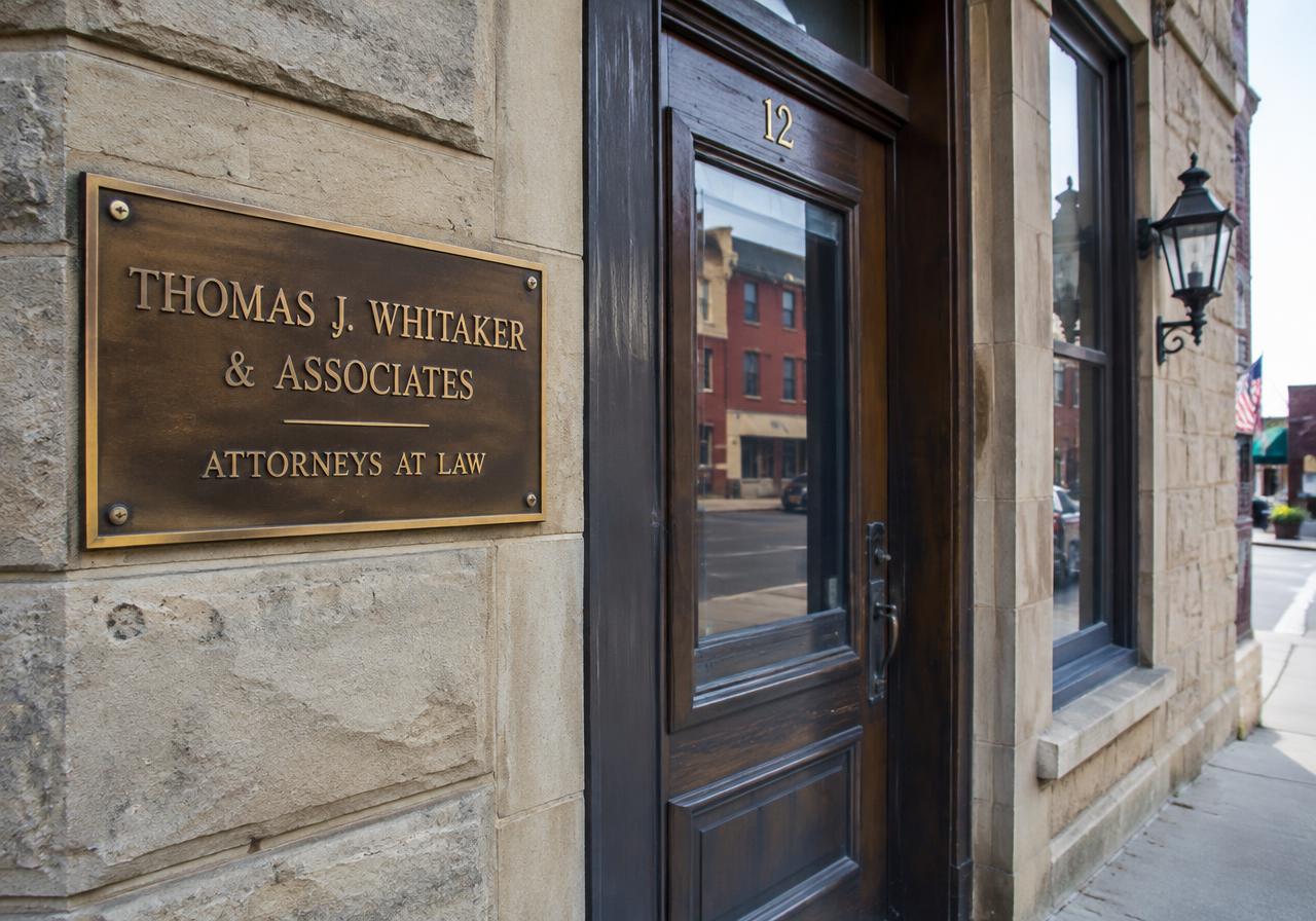 Law firm nameplate beside an office door